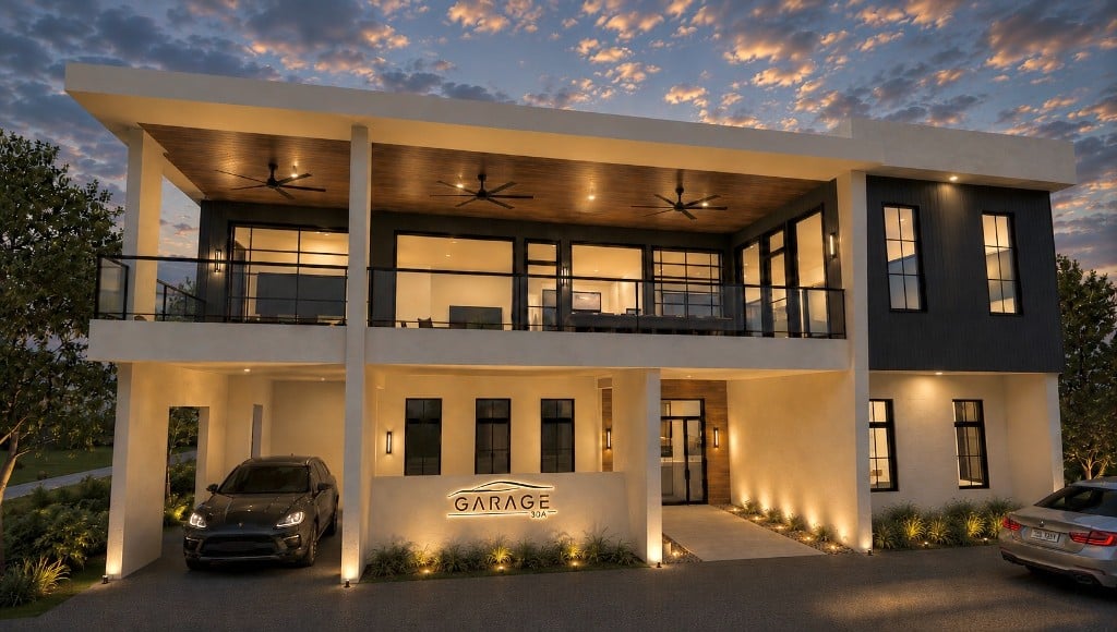 Garage 30A private clubhouse exterior at dusk with luxury vehicles