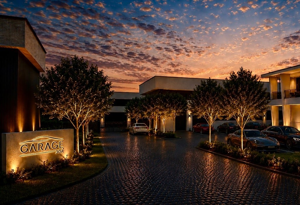 Garage 30A monument sign and landscaped entrance drive at golden hour